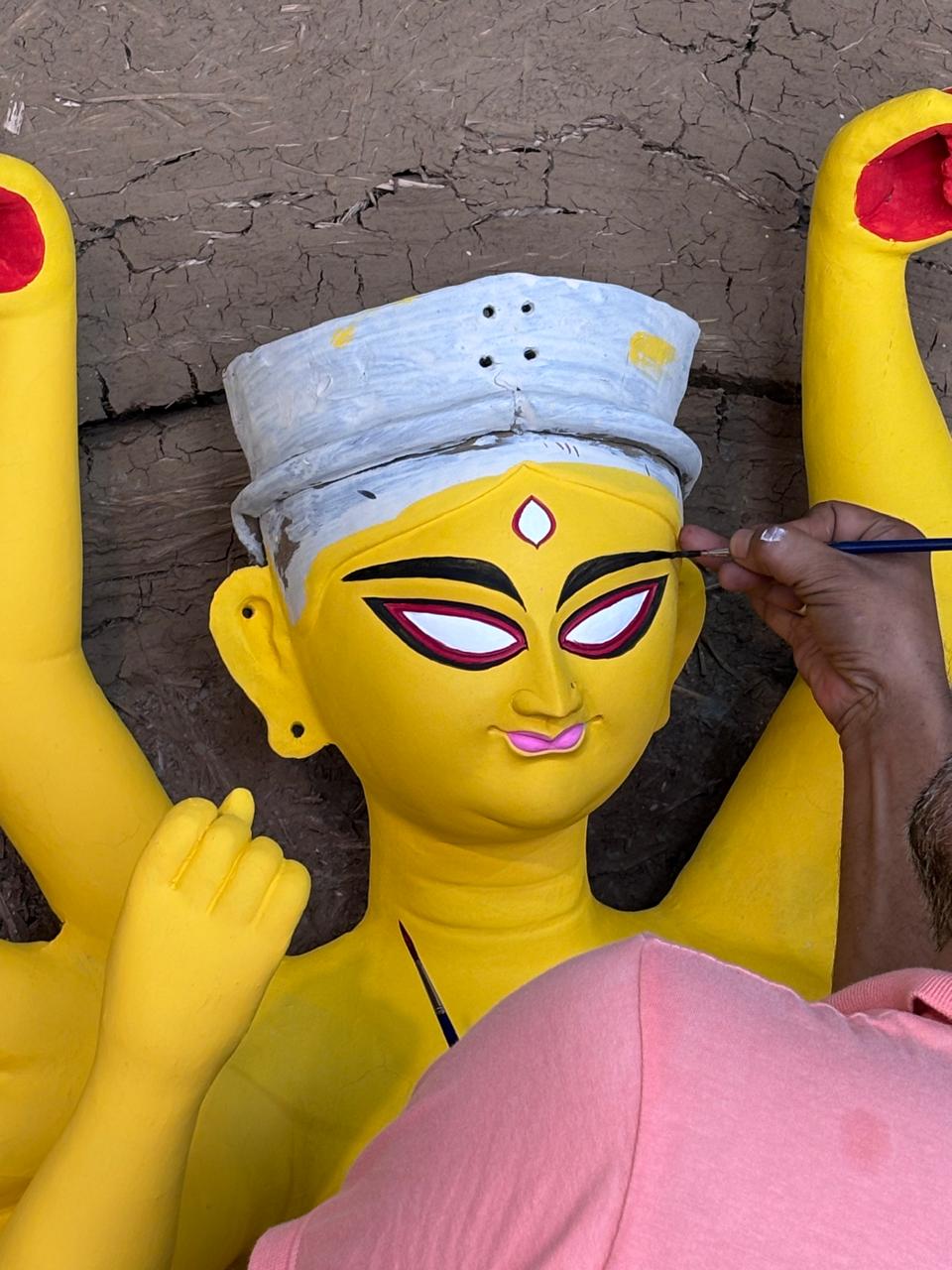 Durga idol being painted ahead of the puja